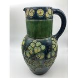 Antique Glazed pottery water jug possibly Scottish. Designed with trees and worded round the