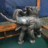 A Solid hardwood carved elephant plant stand. Measures 56x67x23cm