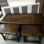 An Ercol dark oak side table with two small side tables