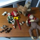 A Lot of vintage toys which includes straw filled dog, Vintage monkey, jester rattle, various carved