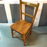 A Vintage childs elm wood chair.