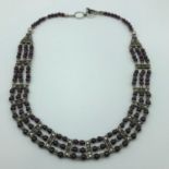 A Silver 925 ornate necklace set with purple bead gem stones.