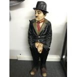 A Rare large Charlie Chaplin figure, Holding a stick under his arm. Made from a resin material.