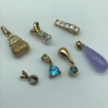 A Lot of seven 9ct gold pendants and charm.