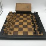 Antique wooden chess board with hand made chess pieces.