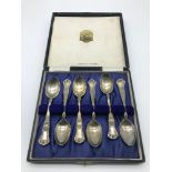 A set of 6 Ornate Birmingham silver tea spoons within a fitted case, Docker & Burn Ltd, dated 1925.