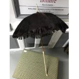 A Lovely example of a Victorian parasol, silk material, Ivory turned handle and top.