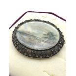 A Large silver filigree and miniature painting brooch. Painting is covered with a glass front.