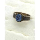 A Victorian 9ct gold mourning ring, set with a single blue stone engraved with a cross, weaved