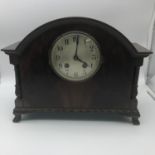 Antique mantle clock supported on ball and claw feet. Measures 25x31.5x12cm