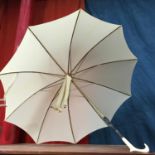 A Ladies Antique Tolido parasol in ivory white, Styled with Ivory handle and comes with cover.