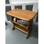 An Ercol blonde side table, magazine rack.