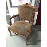 A reproduction bedroom carver chair styled in leopard print material.