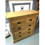 A solid light oak contemporary 2 over 3 chest of drawers. Measures 103.5x96x41cm
