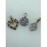 Three 9ct gold pendants, Diamond cluster, Amethyst cluster and diamond and ruby heart pendant.