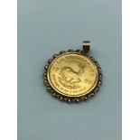 A 1/4 Oz Krugerrand gold coin dated 1980. Within a 9ct gold pendant casing