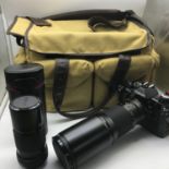 Canon AE-1 Program camera with Tokina 400mm lens, Canon Lens FD 200mm lens and carry bag.