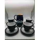 A 9 piece Denby tea set in a blue-green colour together with a Denby jug in dark blue