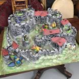 A Vintage 1970's moulded plastic castle together with a collection of 1970's Britains figures.