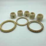 A Lot of early 1900's carved ivory bangles and 6 napkin rings with unusual markings to each