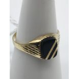 A 9ct gold and onyx ring. Size N.