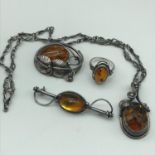 A Beautiful Silver and Amber set. Includes Ornate pendant with necklace, 2 Brooches and ring.