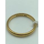A 22ct Gold wedding band, size O. Weighs 3.30grams