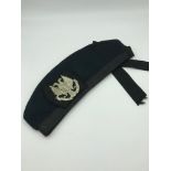 Glen Garry Beret hat with military badge.