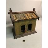 Antique wooden house done in the style of a cuckoo clock with two moving figures.