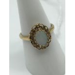 A 9ct gold and large opal stone ring. Size O.