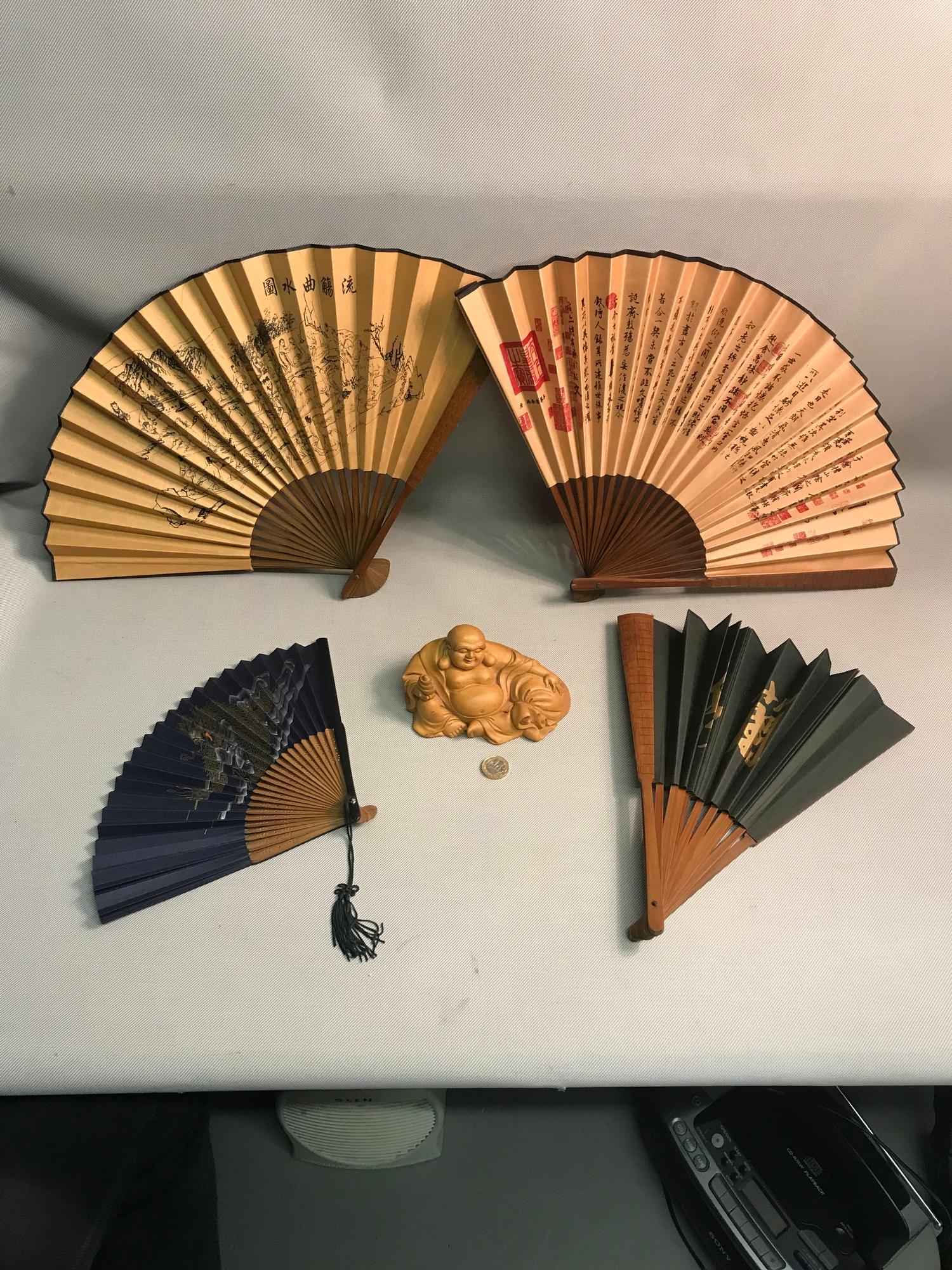 A Lot of 4 Chinese hand painted fans together with wooden carved laughing buddha
