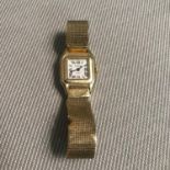 A 14kt gold ladies Geneve Quartz watch styled with a square face, 7 Jewels. Weighs 26.11grams.