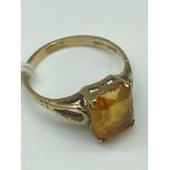 A 9ct gold ladies ring set with a large square citrine stone.