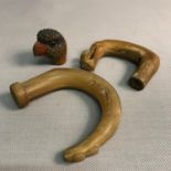 A Wooden hand carved parrots head for the top of a walking cane together with two horn carved tops.