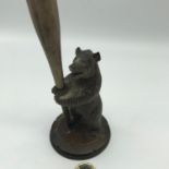 Antique Black Forest hand carved bear figure holding a paint brush.