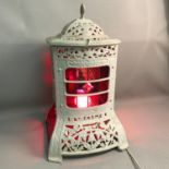 A white painted cast metal stove converted to lantern, fitted with stain glass, height 49cm