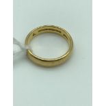 A 22ct gold wedding band, size L. Weighs 5.07grams