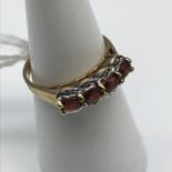 A 9ct gold and Ruby set ring, Small diamonds to the sides. Size M.