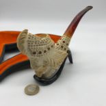 A Highly detailed carved meerschaum pipe with stand and case.