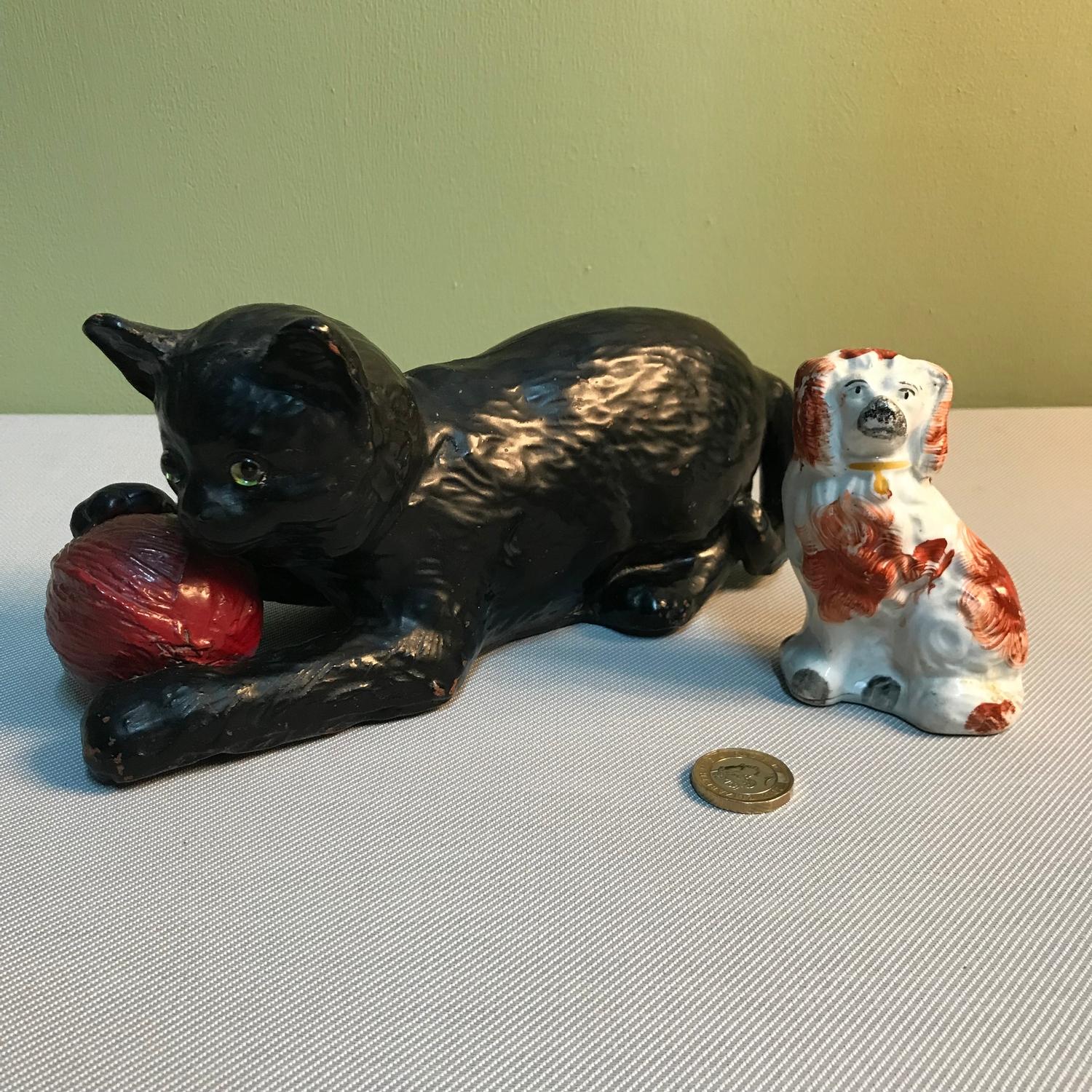 A Vintage Bretby cat and ball figurine together with an antique Staffordshire left wally dog. Cat