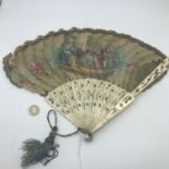 A Victorian ladies fan, hand painted with Victorian figures, Handle is made from bone, Finished with