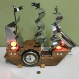 A Vintage S.E.C. Smiths clock displayed in a light up galleon model, Styled with chrome sails and