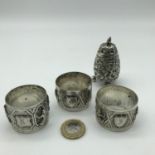 Indian silver pepper pot and three matching napkin rings