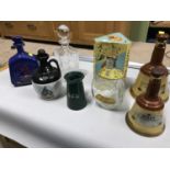 A Quantity of whisky decanters and flagons which includes An old empty Dimple bottle with original