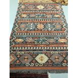 A Large hand woven Aztec style rug, Measures 241x168cm