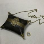 A vintage brass and horn clutch bag