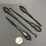 A Lot of 4 silver handled manicure utensils and button hooks