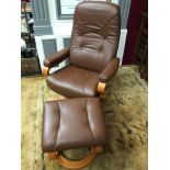 Contemporary Himolla German tan stressless arm chair and foot stool, Very good condition. Revolves