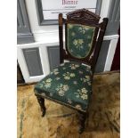 A Victorian parlour chair, supported on turned support legs