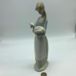 Lladro lady holding a lamb figurine, Measures 26.5cm in height